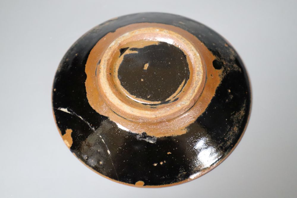 Attributed to Shoji Hamada (1894-1978). A shallow circular persimmon-glazed dish, diameter 18cm (damage)